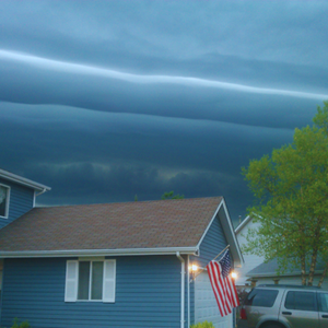 House with storm looming behind it